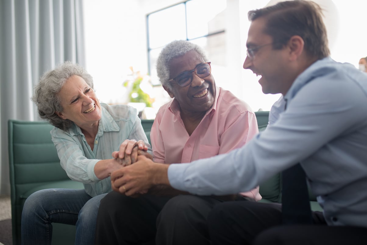 A Man Shaking Hands with Elderly People